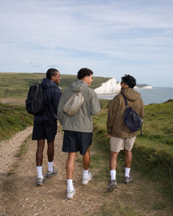 Three friends hiking along a coastal cliff path