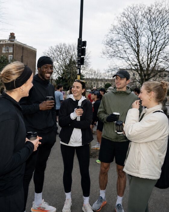 Friends catching up with drinks at a run club